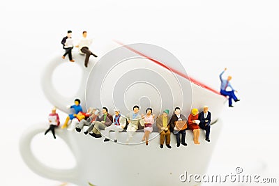 Miniature people : Business team sitting on cup of coffee and having a coffee break. Image use for business concept Stock Photo