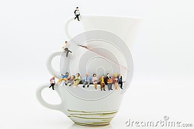 Miniature people : Business team sitting on cup of coffee and having a coffee break. Image use for business concept Stock Photo