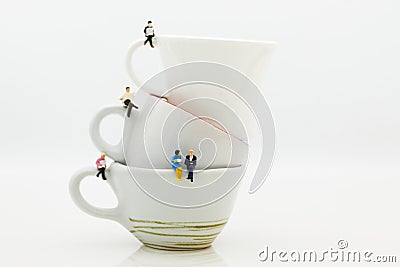 Miniature people : Business team sitting on cup of coffee and having a coffee break. Image use for business concept Stock Photo