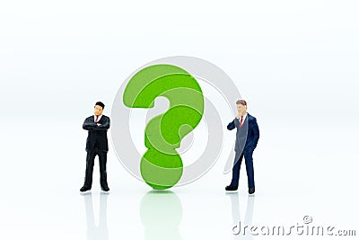 Miniature people : Businessman and question mark. Image use for find answers, solution, business concept Stock Photo
