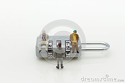 Miniature people: Businessman sitting on master key encoding. Image use for background security system, hack, business concept Stock Photo