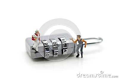 Miniature people : businessman sitting on metal security lock key with thief. Stock Photo