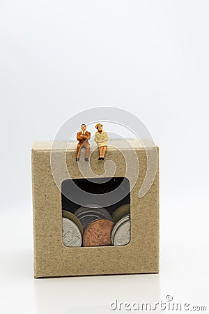 Miniature people: Businessman sitting on money box , profit margins of background. Image use for business solution concept Stock Photo