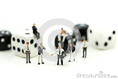 Miniature people : businessman standing with Black and white dices,Business competition Concept. Stock Photo