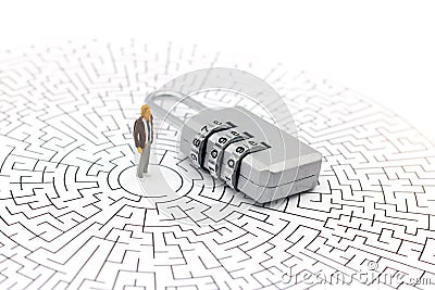 Miniature people: Businessman standing on center of maze with key and thinking how to solve this problem. Concepts of finding Stock Photo