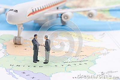 Miniature people, businessman standing on map American Stock Photo