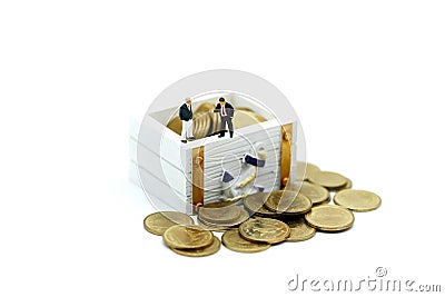 Miniature people : businessman with treasure coffer of gold. Stock Photo