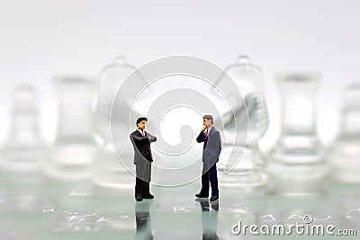 Miniature people, Businessmen stand on opposite sides of the chess game, separate party , benefit, use as a business competition Stock Photo