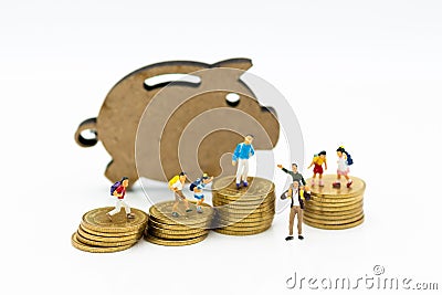 Miniature people: Children group with Piggy bank standing and stack of coins. Image use for investment, saving money Stock Photo