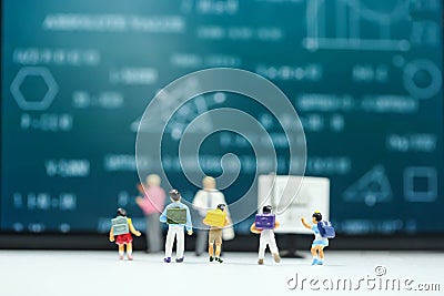 Miniature people : children and teacher with math blackboard background. Back to school concept. Stock Photo