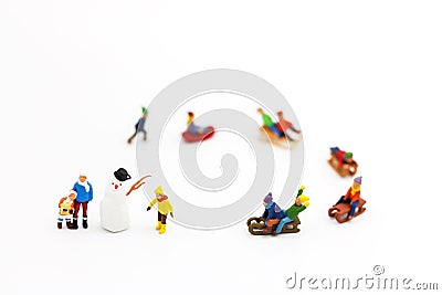 Miniature people: Childrens playing fun with snow slider Stock Photo