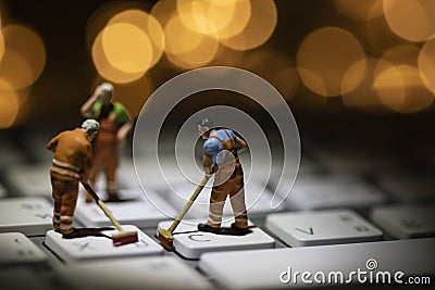 Miniature people cleaning white keyboard computer Stock Photo