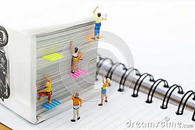 Miniature people: Climber climbing on book . Image use for learning, education concept Stock Photo