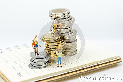 Miniature people: Climbers are climbing coins. Image use for moving forward to success, business concept Stock Photo