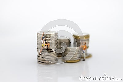 Miniature people: Climbers are climbing coins. Image use for moving forward to success, business concept. Stock Photo