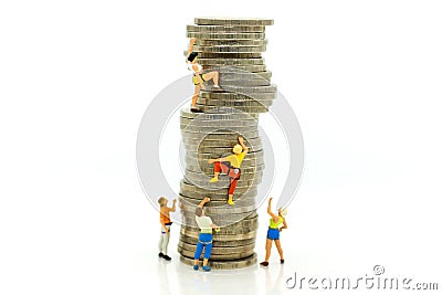Miniature people: Climbers are climbing coins. Image use for moving forward to success, business concept Stock Photo