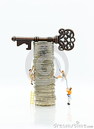 Miniature people: Climbers are climbing coins to get to the Master keys. Image use for moving forward to success, business concept Stock Photo