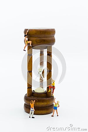 Miniature people: Climbers are climbing hourglass. Image use for time of business concept Stock Photo