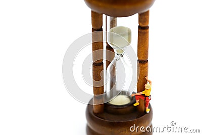 Miniature people : climbing with Sandglass, hourglass. Stock Photo
