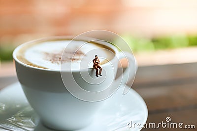 Miniature people : Coffee cup with businessman , image use for charge your energy in the morning Stock Photo