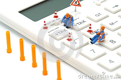 Miniature people Construction worker Keypad TAX button For tax calculation. Easy to calculate. on White calculator on white backgr Stock Photo