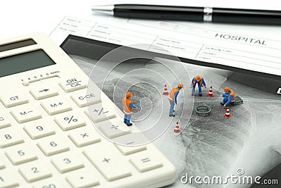 Miniature people Construction worker on white calculator with Lung x-ray .using as background Healthcare concept and Medical conce Stock Photo