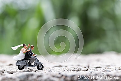Miniature people : Couple riding the motorcycle Stock Photo