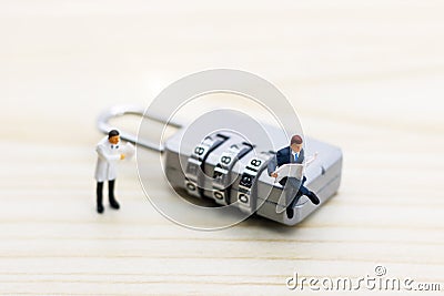 Miniature people are decrypting unlock padlock, Decrypt the key. concept for data security breach, risk and hacker attack Stock Photo