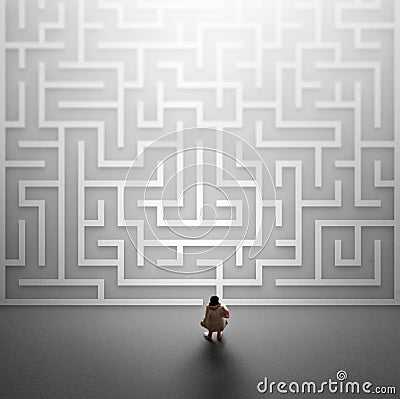 Miniature people entering a maze. Problems in Life concept. Stock Photo