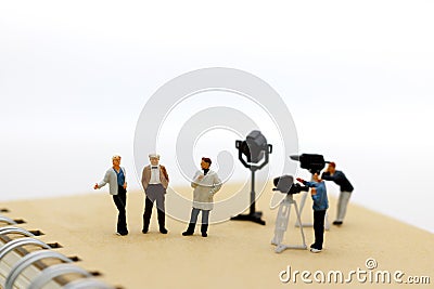 Miniature people: female journalist making an interview a man Stock Photo