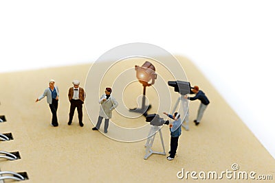 Miniature people: female journalist making an interview a man Stock Photo