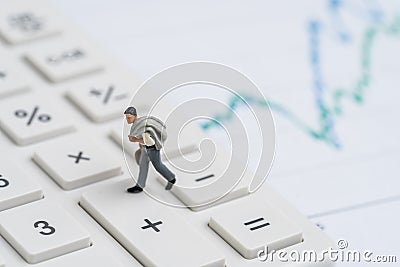 Miniature people figurine businessman walking on calculator from minus to plus button with graph and chart using as stock go up, Stock Photo