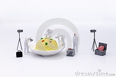 Miniature People and food, check the nutritional value, nutrients received in each meal. Image use for food and beverage concept Stock Photo