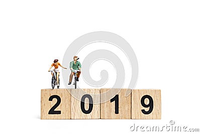 Miniature people : Friend Group ride bicycle with wooden number 2019 Stock Photo