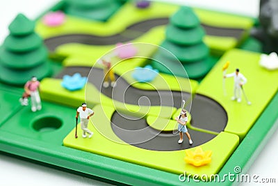 Miniature people : golfer stand with children`s toys collection, Stock Photo