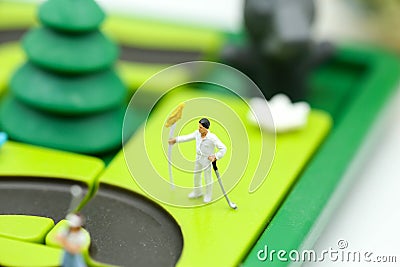 Miniature people : golfer stand with children`s toys collection, Stock Photo