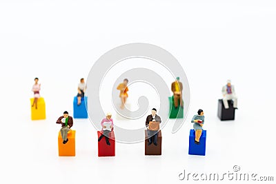 Miniature people: Group people sitting on colorful block. Image use for relax time concept, spending time for free Stock Photo