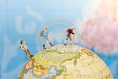 Miniature people: Group traveler backpack stand and walking on world map. Image use for travelling or business trip concept Stock Photo