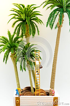 Miniature people: Guy climbs the ladder to collect fruit from the tree. and children keep fruits below. Image use for daily Stock Photo