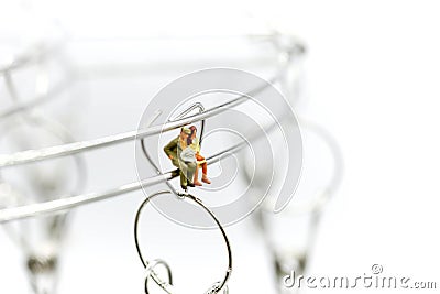 Miniature people : Joyful swinging on a swing,Fun and happiness Stock Photo