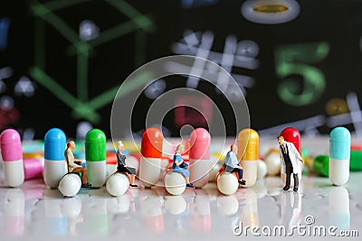 Miniature people : man working on capsule drug using for healthy Stock Photo