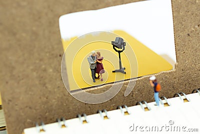 Miniature people: Moderator are interviewing guests with camera and video capture. Image use for Entertainment Industry Stock Photo
