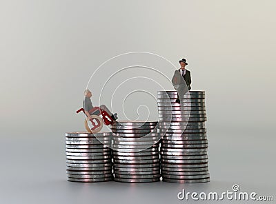 Miniature people in piles of coins of different heights. The concept of employment inequality for the disabled. Stock Photo
