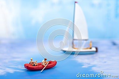 Miniature people, Rowing boat in the ocean. Image use for sports concept Stock Photo