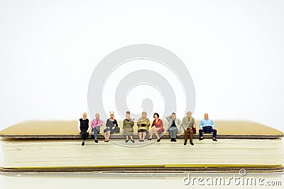 Miniature people sitting on a book. Image use for background education, business concept Stock Photo