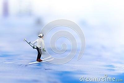 Miniature people, Skier playking ski on snow stream. Image use for sport ,travel concept Stock Photo