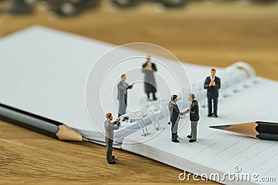 Miniature people, small figure businessman handshaking and other Stock Photo