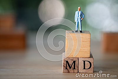 Miniature people stand on cube block on with word MD : Managing director Stock Photo