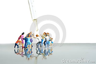 Miniature people toy figure photography. Group of people jostling for vaccine Stock Photo