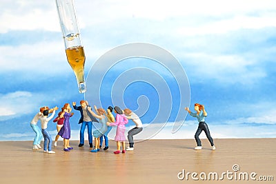 Miniature people toy figure photography. Group of people jostling for vaccine Stock Photo